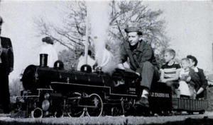 Off on a 1,000 foot journey on a back-yard track, Bob Harpur here has under steam a 1-1/2 inch scale model of an Atlantic-type locomotive, assembled from a Little Engines kit.