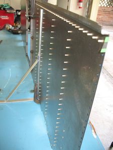 This is the backside of the panel before bucking the rivets. Without the tape, these would all fall out as soon as you set the first rivet.