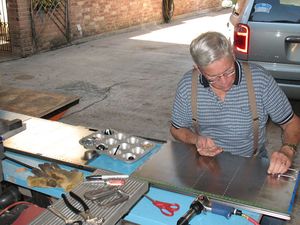 Here I am installing all the rivets on one panel. The blue tape is to keep me from installing rivets where they don't go just yet. The top row of rivets has already been taped.