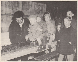 Scene at the Hobby Show of the Victoria, B.C. group in April 1950, shows Cliff Blackstaffe hauling a load of kids on the Exhibition Track with his "O" Gauge C&O live steam Pacific loco. This little steam loco has actually hauled the amazing load of over 300 pounds (two hefty adults). Carl Purinton, our Danvers Brotherhood Secretary can verify its ability at adult passenger work since he got a ride behind this engine while on a trip up that way in the summer of 1950. For this type of stunt the "O" gauge loco is coupled to the larger gauge passenger car and does its stuff. The engine was originally coal-fired, but was changed over to an gasoline vaporized burner for convenience in firing up and handling during these passenger hauling chores. "The Live Steamer", Sep-Oct 1950