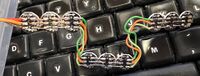 Photo showing how nine WS281 LEDs are "daisy chained" together to form three signal heads with three LEDs each.