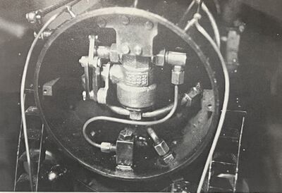 The Valve shown mounted in a 5-1/4 inch smokebox. Special mounting shows steam admitted in the side of the valve. This was done to fit existing dry-pipe connection on boiler. The steam lines from the dry-pipe come forward from the front flue sheet, one on each side of the stack. The 1/8 inch diameter line is the supply from the lubricator.