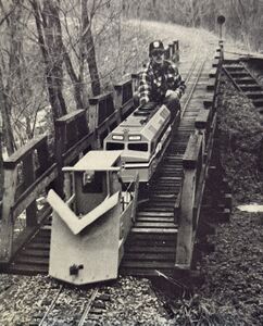 Paul Fitt with the LM&W F-40PH, pushes his ready-for-finish-paint Jordan Spreader (sans snow) over Trestle #1 towards the Station Area.