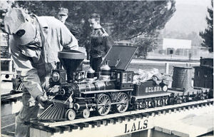 Mark Piper, retired city employee, pretties up his 1-1/2 inch scale American engine, car and caboose. He built the whole thing himself, with more than 5,000 hours of patient work.