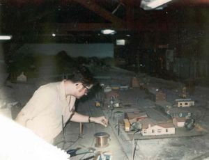 "Key Route" Ken Shattock hanging overhead wires for an O gauge interurban layout, circa 1975.