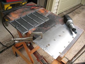 Door panels are welded up and I am getting ready to grind the plug welds and backsides of the rivets flush. The instructions don't say anything about this but if you don't the door won't slide in it's tracks.