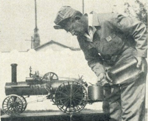 Mark Piper gives his tractor a drink.