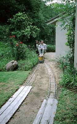 Note how the track bed changes in front of the house - for most of the loop, there are wooden crossties under the track, but in front of the house, there is a concrete foundation for the rails.