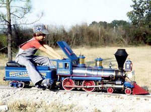 Jason Adams at the throttle nearing the old well house at the Annetta Valley & Western RR, about 1977. The lettering was all hand painted, including the mural on the headlight, by former Disney artist "Hoppy". Photo by Terry Adams.