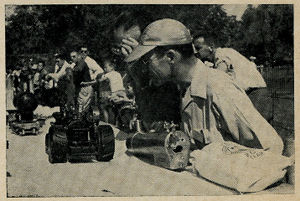 Titus of Mattoon looks over the traction engines. Bag of Welsh coal is seen in foreground.