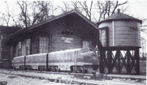 Two powered A units and a dummy B unit, all by Backyard Rails, wait at the station for passengers on the Browning Division of the Denver & Rio Grande Western Railroad.