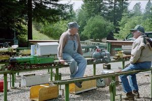 Gordon French relaxing with a friend at the Golden Gate Live Steamers track, 2015. Gordon's green Maisie is on the left, and his Tich is on the right.