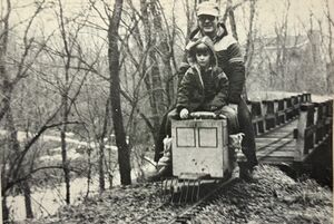 Bill Hamil gives encouragement to a young, potential Live Steamer at the controls of his Railbus still under construction.