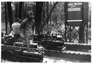 From Bruce Mowbry. An oldie from 1975 -ish. In the foreground is Ed Loomie's 4-4-0, myself on the center track with my newly finished LIttle Engines 0-4-0-T, and Ken Owens with his mostly scratch build Little Engines 0-6-0 on the far track. This was the first time I had my locomotive out at the Long Island Live Steamers track. The bobber caboose was a school shop project, the flat car built from old bedframes and scrap wood with Nelson Gray trucks. The locomotive was a "Just bolt em together "kit that required a lot more than just filing and fitting. My father took this photo with his 4x5 Speed Graflex Speed Graphic camera and personally developed the image in his dark room at the print shop where he worked at his second job in the evenings.